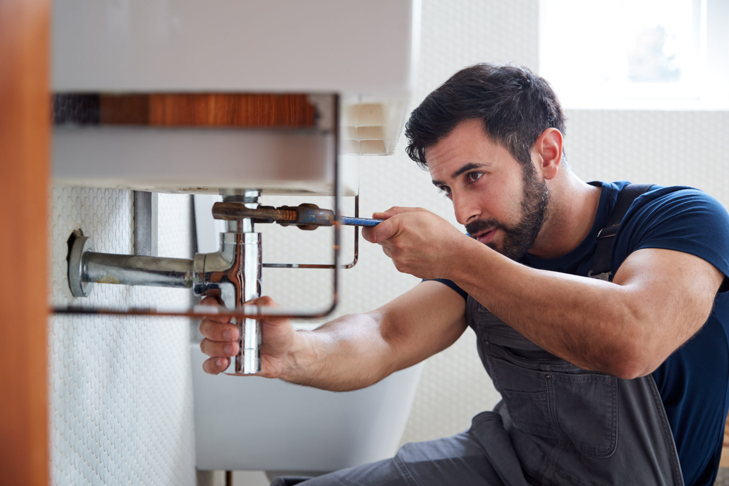 Plumber repairing pipe